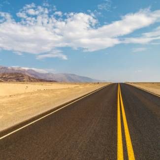 Road under blue sky with clouds